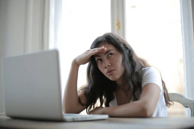 image of a women looking concerned at her work laptop